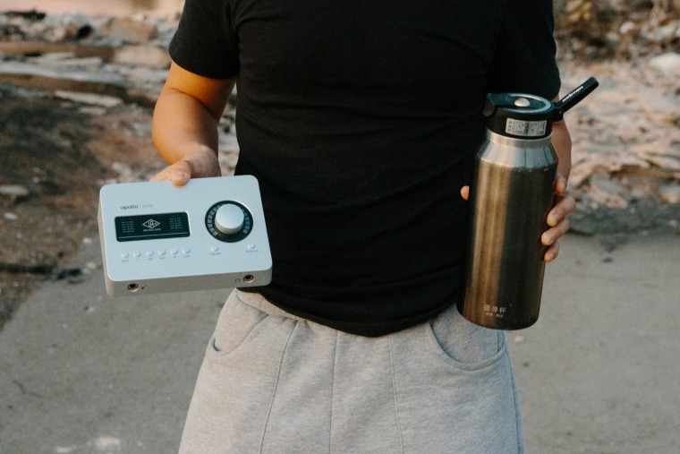 Sam, 17, with some of the items he saved: an audio interface for music production and a water bottle from China.