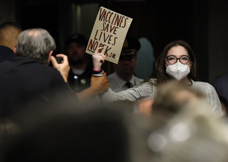 A protester is removed as Robert F. Kennedy Jr. testifies during his Senate Finance Committee confirmation hearing on Jan. 29, 2025.