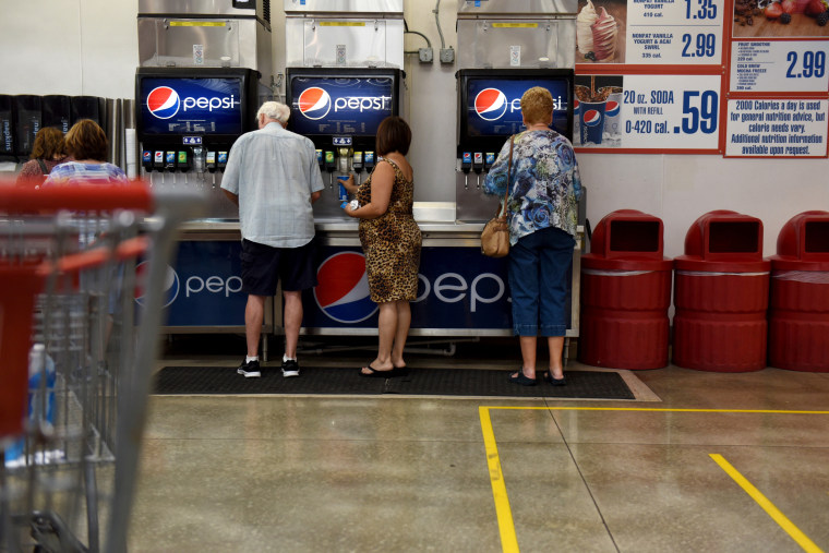 Customers fill cups with PepsiCo. Inc. brand beverages at the food court of a Costco Wholesale Corp. store in San Antonio, Texas, U.S., on Wednesday, May 30, 2018. Costco Wholesale Corp. is releasing earnings figures on May 31. 