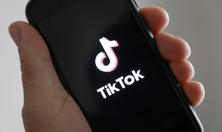 The home page of the social media application TikTok is displayed on the screen of an iPhone.