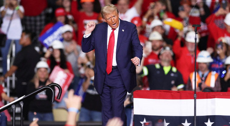 Donald Trump dances on stage after speaking at a campaign rally.