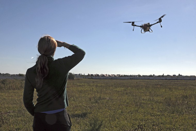 USAID Head meets wUSAID Administrator Samantha Power watches the flight of a drone sprayer in Ukraine