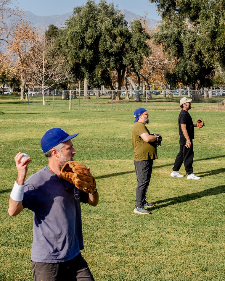 Members of a baseball league play catch.