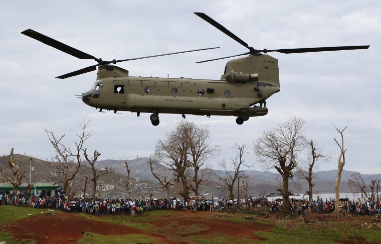 US military helicopter takes off after unloading USAID relief supplies in Haiti