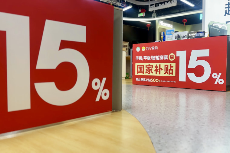 Banners at an electronics retailer in Beijing advertising government subsidies on smartphones and other devices to boost consumer spending.