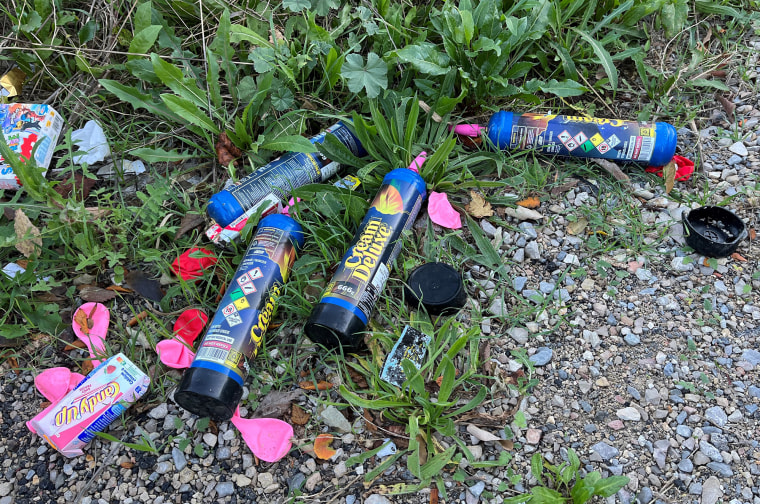 Discarded balloons and canisters of nitrous oxide on a street in Montpellier, southern France, in 2023.