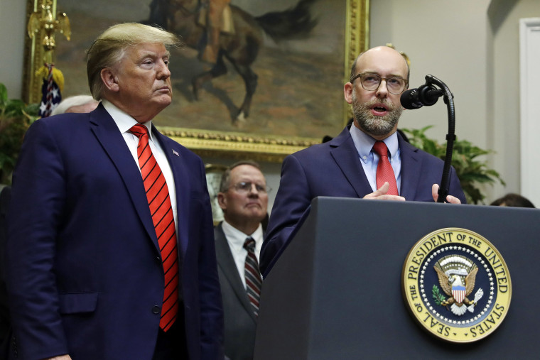 President Donald Trump listens as acting director of the Office of Management and Budget Russ Vought speaks at the White House in 2019.