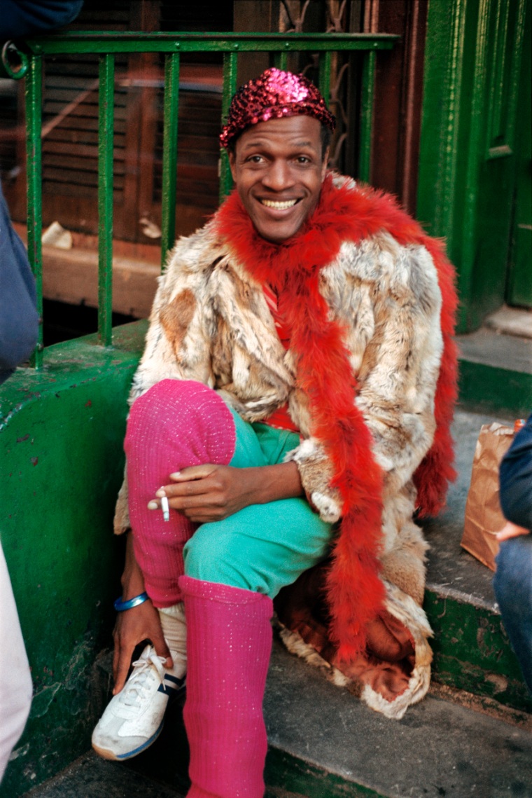 Marsha P. Johnson sits on a stoop