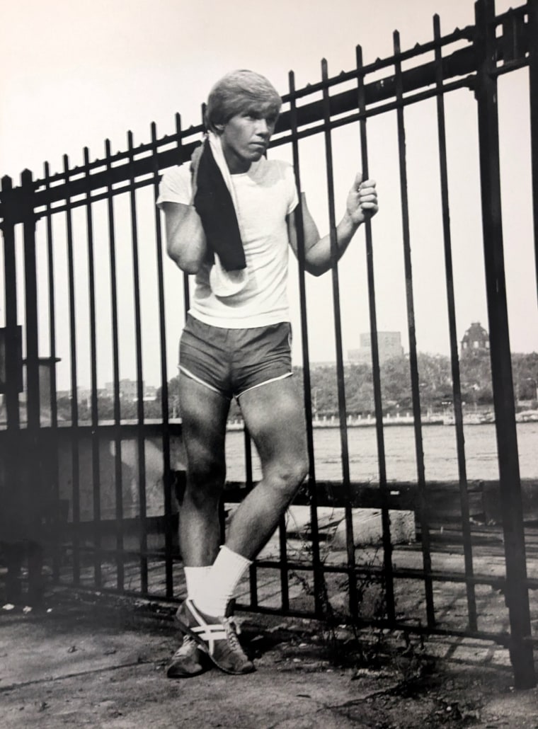 Michael Hawke stands by a metal fence outside