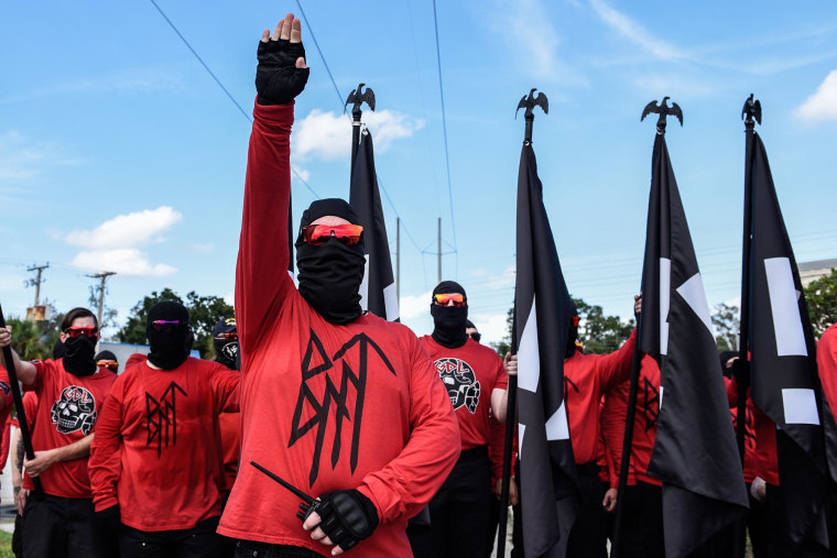 A member of the neo-Nazi group Blood Tribe salutes at a rally on Sept. 2, 2023 in Orlando, Fla.