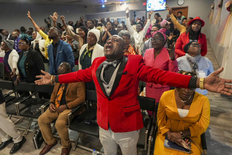 Congregants pray.