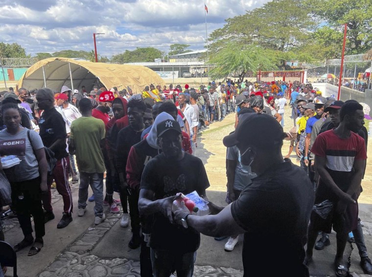 Haitians line up at a non-profit help center to receive food after being deported from the Dominican Republic, in Belladere, Haiti, on Jan. 30, 2025.