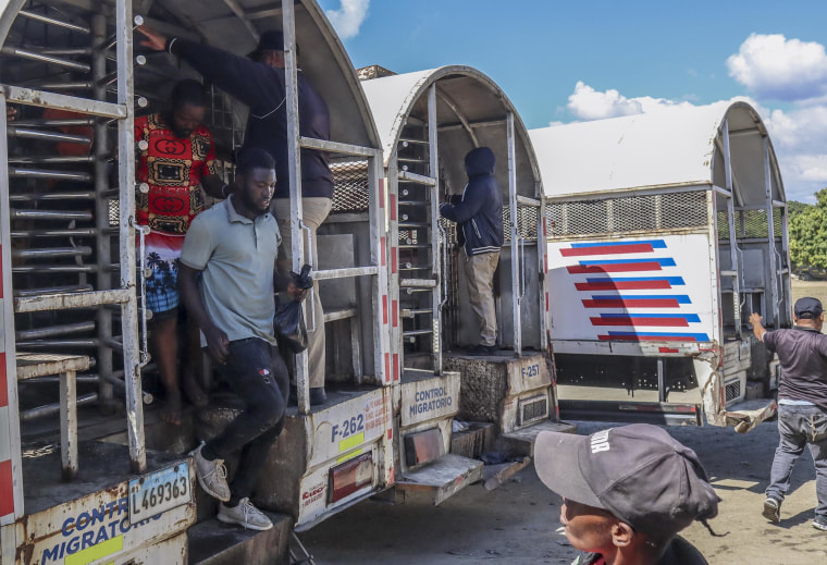 Haitians deported from the Dominican Republic step out of trucks in Carrizal on the border with Haiti on Jan. 30, 2025. 