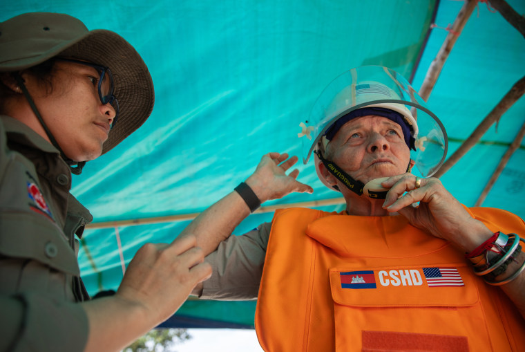 Bill Morse puts on personal protective equipment before entering a landmine field in Siem Reap.