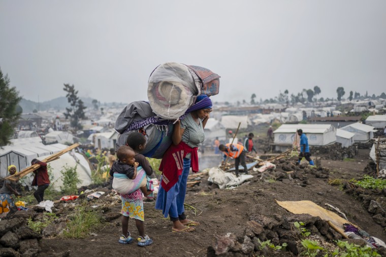 People carry their belongings.