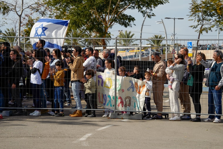 People and friends await for the helicopter with the