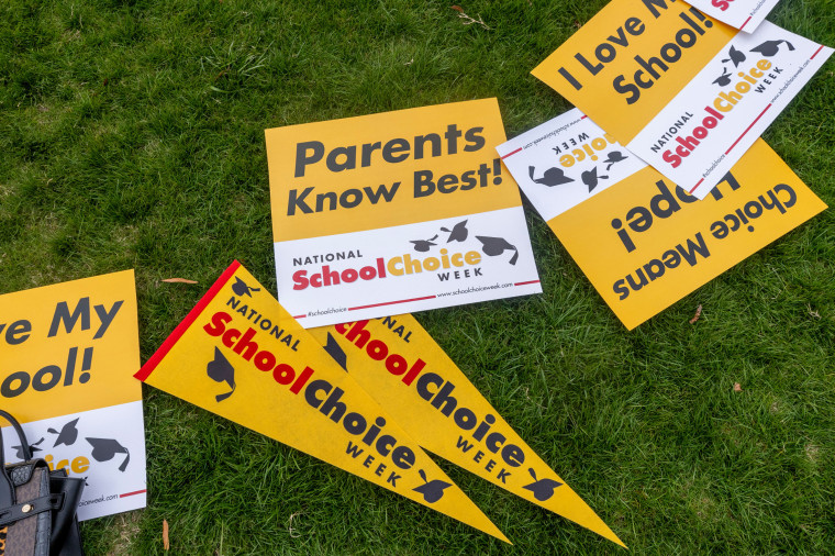 Signs lay in the grass during a rally celebrating National School Choice Week on Halifax Mall in front of the Legislative Building in Raleigh, North Carolina, on Jan. 24, 2024. 