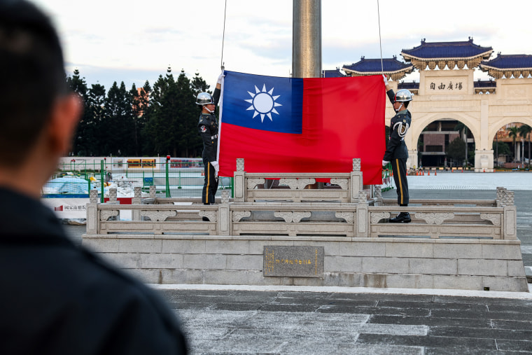 Guards raise Taiwan's national flag