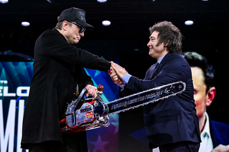 Image: Elon Musk holds a chainsaw reading "Long live freedom, damn it" 