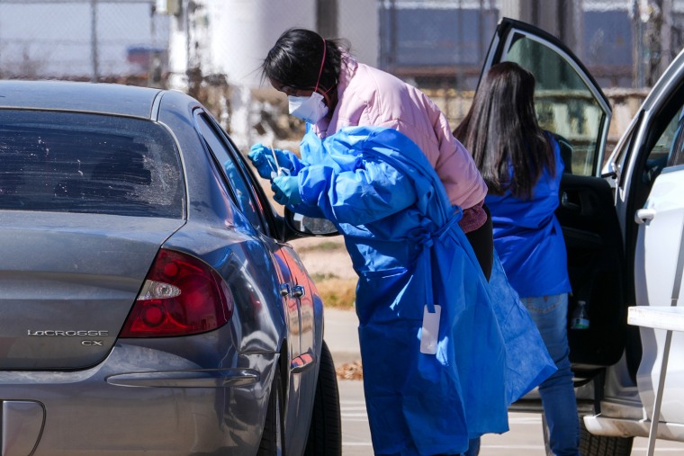 Health operators take care of the tested test with car passengers at the outer mobile test site.