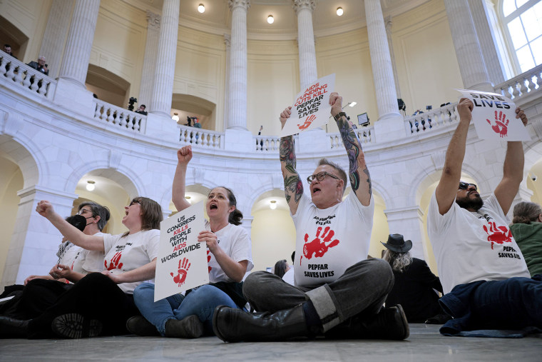 Demonstrators protest funding cuts on the floor of the Capitol Rotunda 