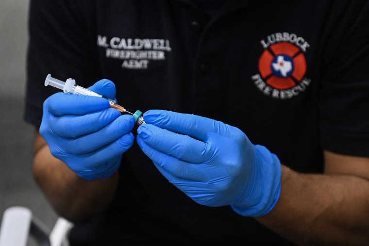 A paramedic administers a dose of the measles vaccine at a health center in Lubbock, Texas, on Thursday.