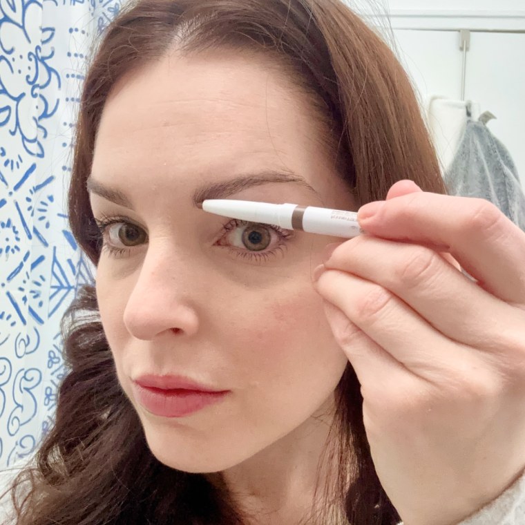 Associate editor Shannon Garlin applying e.l.f. Instant Lift Brow Pencil in neutral brown.