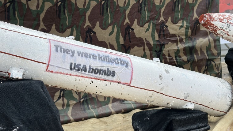 A white missile with text that reads "They were killed by USA bombs"