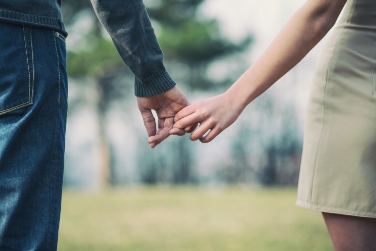 couple holding hands 