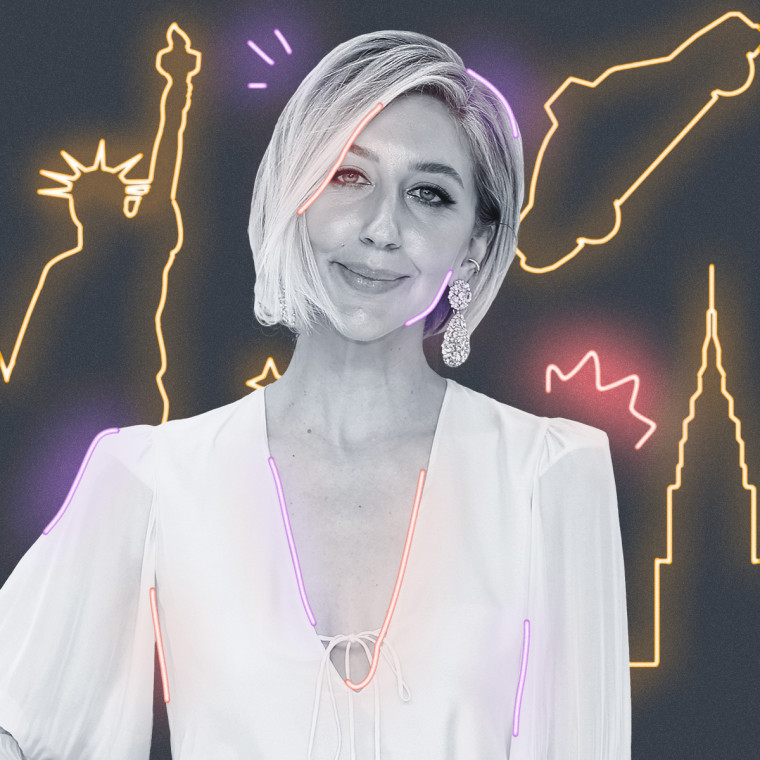 Heidi Gardner with yellow neon signs behind them on a gray background