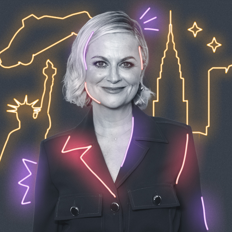 Amy Poehler with yellow neon signs behind them on a gray background