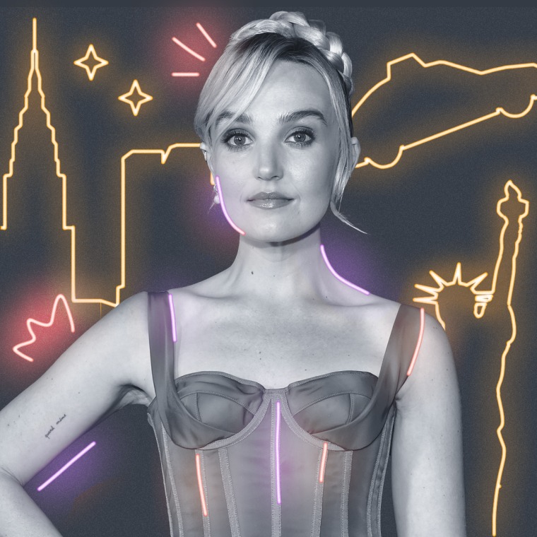 Chloe Fineman with yellow neon signs behind them on a gray background