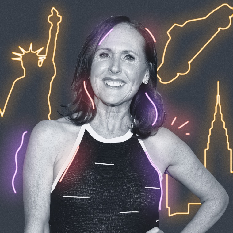 Molly Shannon with yellow neon signs behind them on a gray background