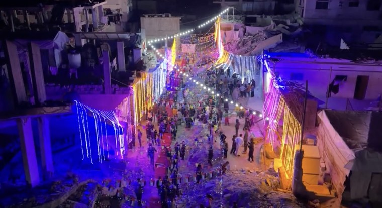 Palestinians in Khan Younis gather for suhoor, a predawn meal, early Saturday morning.