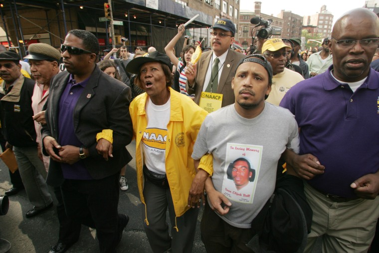 demonstrators march outside, arm in arm