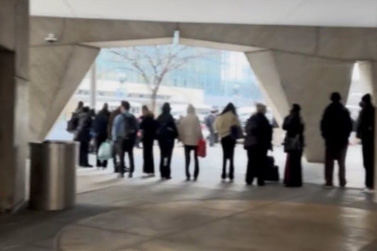 HUD employees wait in line this morning.