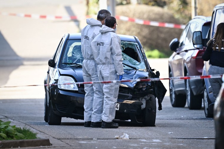 Police stand next to a damaged car on March 3, 2025 in Mannheim, Germany, after a car drove into pedestrians.