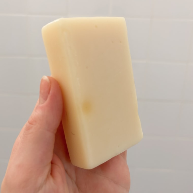 Person holding bar of Megababe shave soap bar.