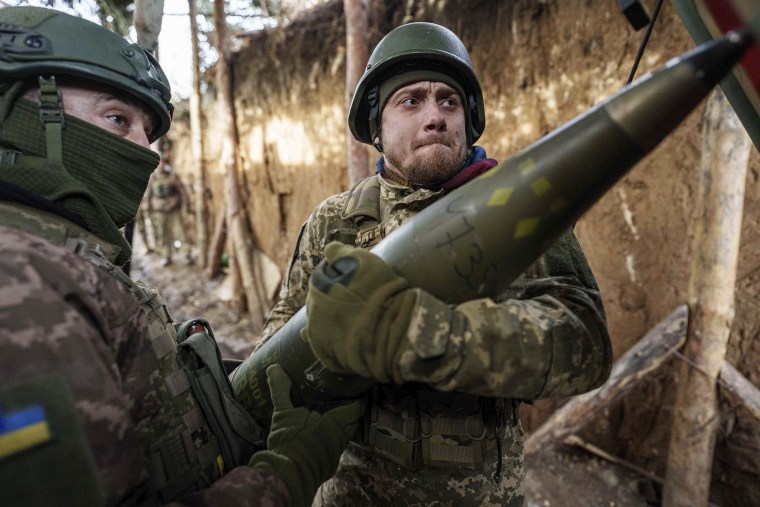 Ukrainian servicemen load artillery