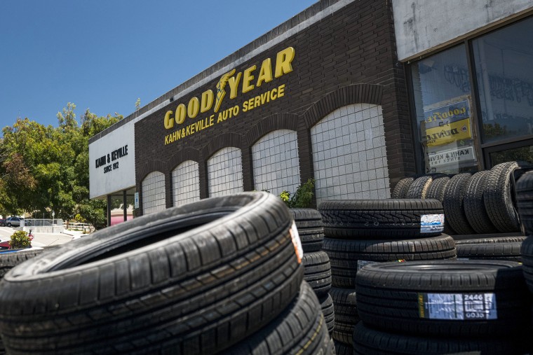 Tires stacked in front of a Goodyear location 