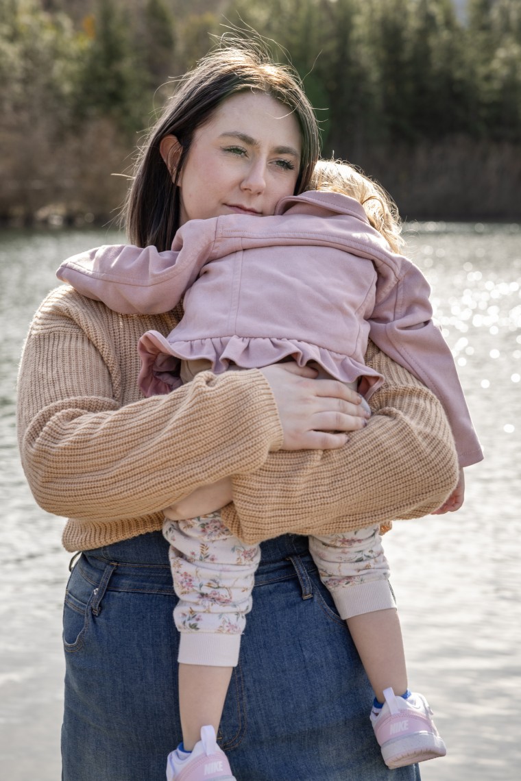 Saige Dahmen holds her daughter at a park in Beaverton, Oregon. 