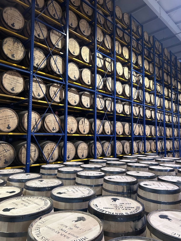 Michter’s bourbon barrels stacked on shelves in a distillery