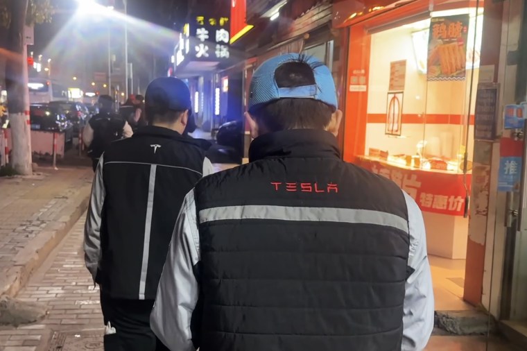 Tesla workers on a street near the Shanghai Gigafactory last month.