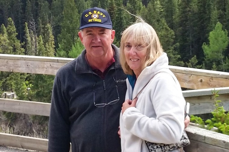 Harve, left, and Janice Smith stand outside together and pose for a photo on a forest walking trail