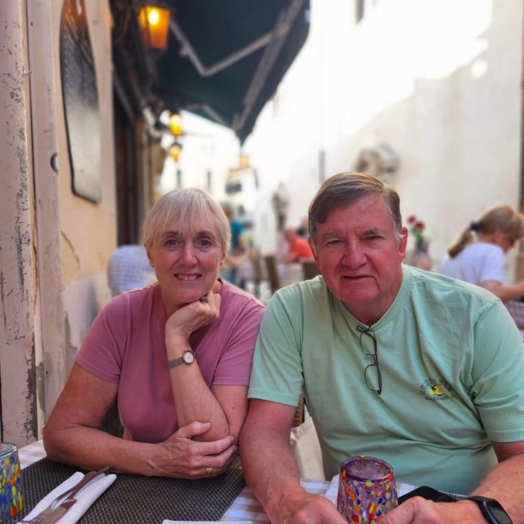 Janice, left, and Harve smith pose for a photo while seated at a table