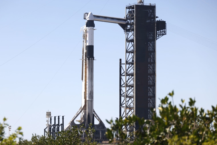 A SpaceX Falcon 9 rocket with the Crew Dragon spacecraft stands ready at the Kennedy Space Center 