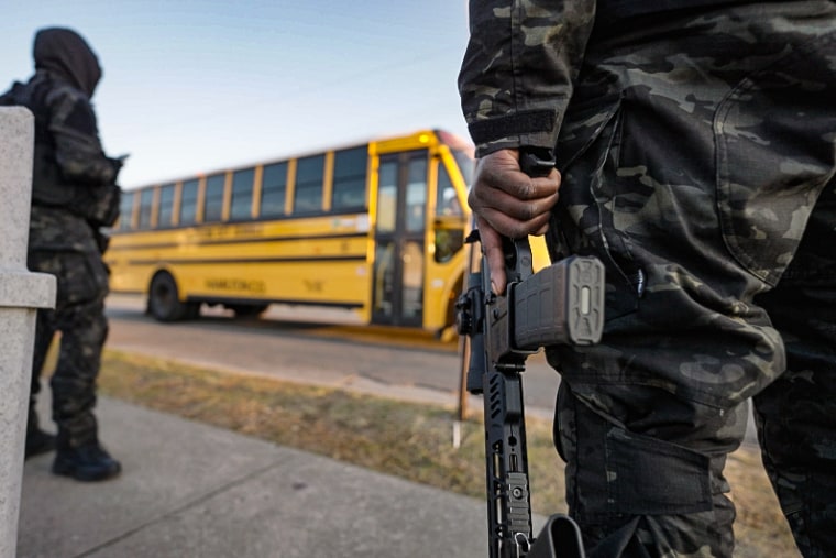 Volunteers start the day by patrolling and monitoring school bus pickup locations