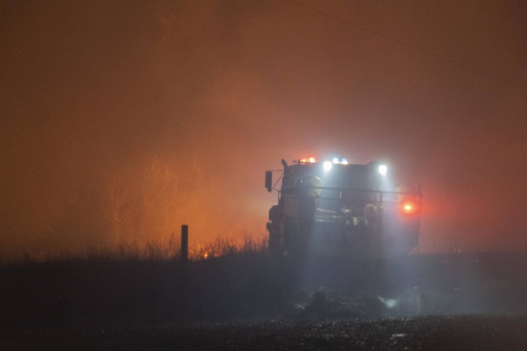 Crews battle a wildfire south of Langston, Okla. 