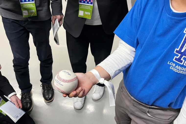 A 10-year-old boy who caught the home run ball hit by the Los Angeles' Shohei Ohtani, shows the ball to reporters