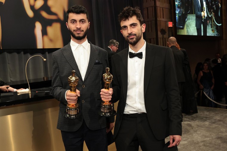 Basel Adra, left, and Yuval Abraham hold their Oscars for Best Documentary Feature.